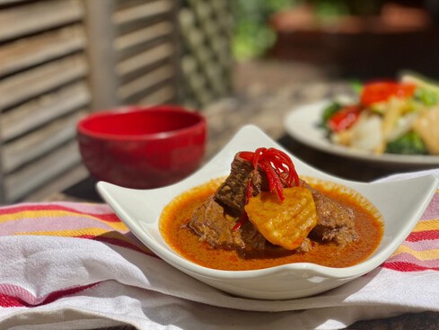 Massaman beef curry with kipfler potato and peanuts in a bowl.